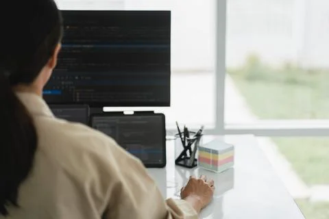 Developer programmer checking code on multiple monitor while programming to.. 스톡 사진