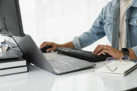 Developer programmer checking code on multiple monitor while programming to.. 스톡 사진