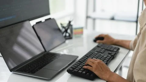 Developer programmer checking code on multiple monitor while programming to.. 스톡 사진