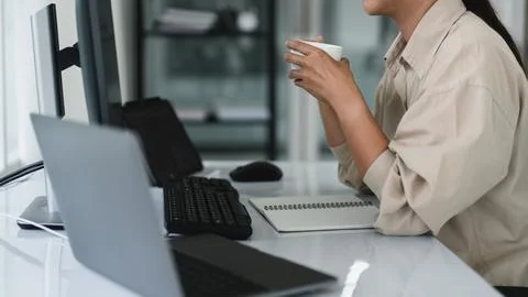 Developer programmer drinking coffee and checking code on monitor for progr.. Stockfoto's