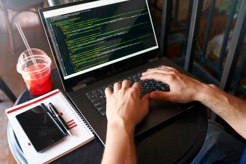 Developer programmer with laptop. Program code and script data on screen. Young 스톡 사진