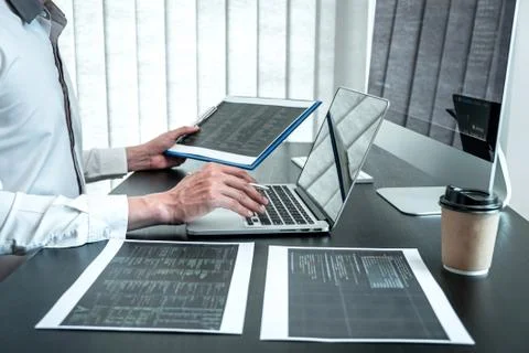 Developer programmer working on coding program software computer in office, W Stock-Fotos