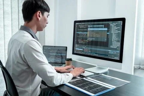 Developer programmer working on coding program software computer in office, W Stock Photos
