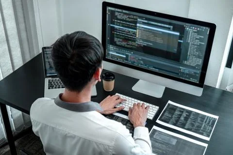 Developer programmer working on coding program software computer in office, W Stock Photos