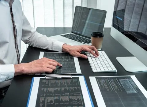 Developer programmer working on coding program software computer in office, W Stock Photos