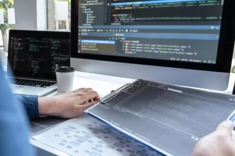 Developer programmer working on project in software development computer in I Stock Photos