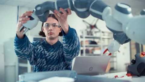 Developer Programming Robot Arm At Laptop Stock Footage 187575016