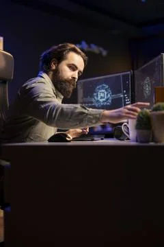 Developer putting cartridge containing malware infected AI bot in PC Stock Photos