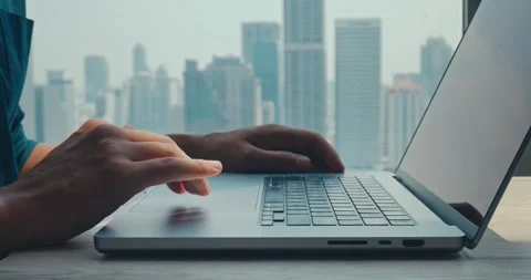 Developer refining code near urban skyline, developer inspired by modern Stock Footage 312123384