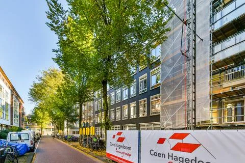 A developer is renovating a building on a street 스톡 사진