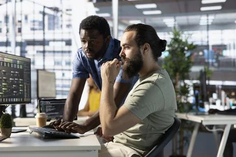 Developer requesting help from colleague while working with machine learning Photos