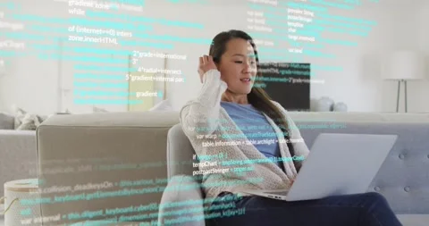 Developer responding to floating code lines by reviewing code on laptop in home Stock Footage 318688368