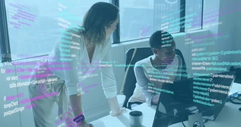 Developer reviewing code after mentor leaning and pointing at monitor in tech Stock Footage 326104227