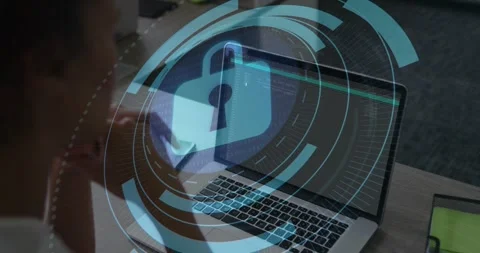 Developer reviewing laptop code fading digital circles converging into padlock Stock Footage 317228652
