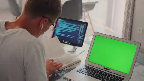 Developer reviews app design on a video call, with a tablet displaying code. Stock Footage 296223452