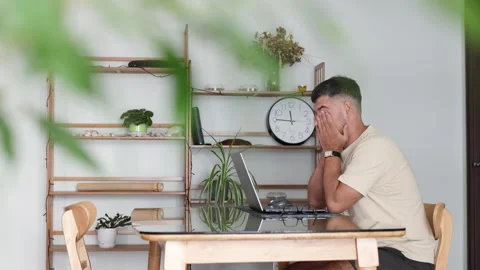 A developer rubs strained eyes from coding. Stock Footage 310526484