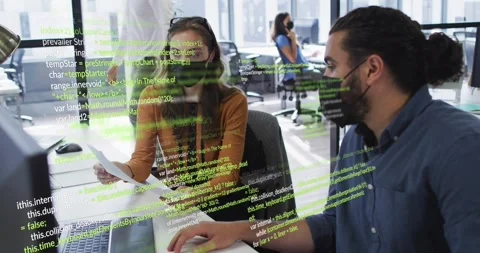 Developer scanning code printout, colleague joining, activating green overlay Stock Footage 318046307