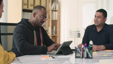 Developer Showing New App on Digital Tablet to His Team during Conference Stock Footage 252573313