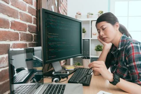 Developer sitting in front of working computer Foto stock