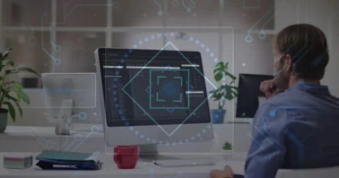 Developer studying monitor while software UI loading, HUD pulsing over monitor Stock Footage 331872467