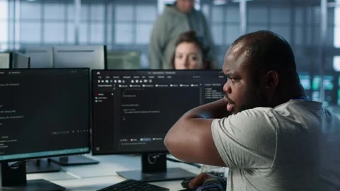 Developer suffering from cold, coughing while typing code on PC in data center Stock Footage 319264990