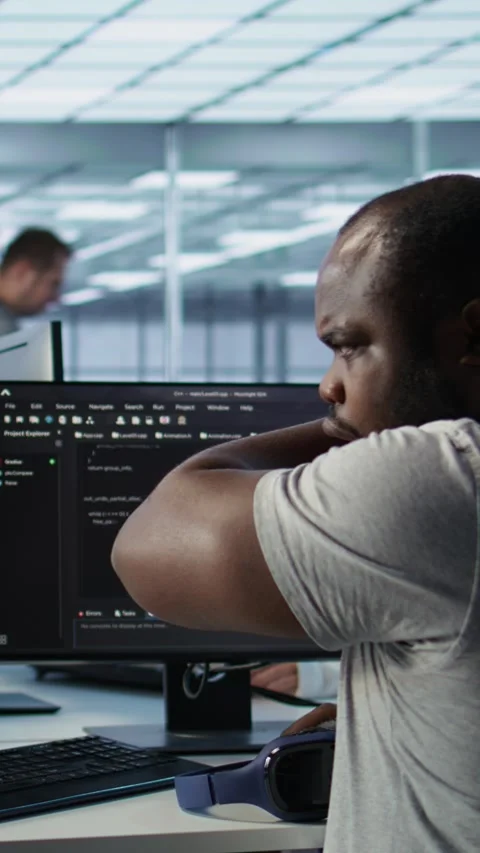 Developer suffering from cold, coughing while typing code on PC in data center Stock Footage 319562425