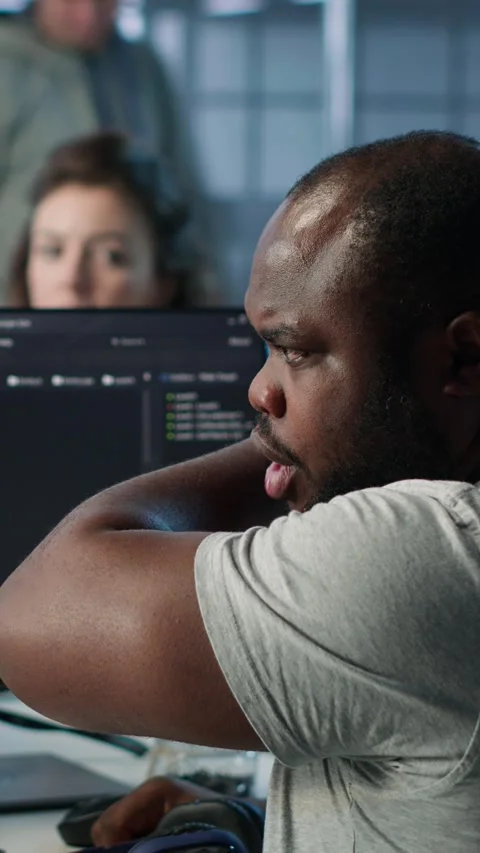 Developer suffering from cold, coughing while typing code on PC in data center Stock Footage 319573047