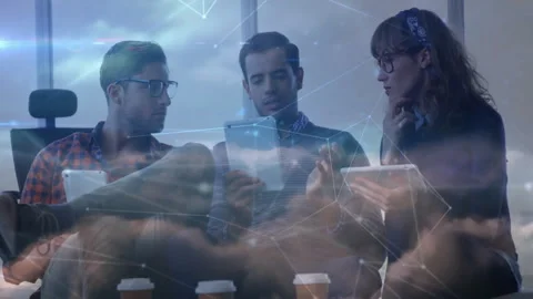 Developer swiping tablet causing colleagues leaning in, graphics emphasizing Stock Footage 312481370