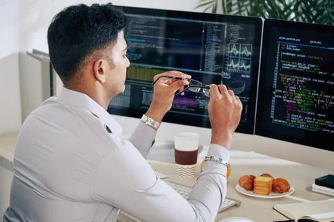 Developer taking off glasses 写真素材