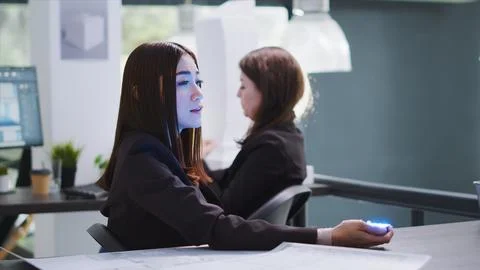 Developer talking to consultant on holographic projection Stock Photos