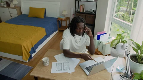 Developer Talking on Phone when Drawing on Paper and Using Laptop at Home Office Stock Footage 300825877
