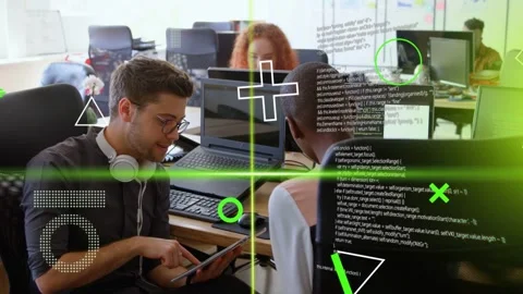 Developer tapping tablet, explaining app to teammate in office, green code Stock Footage 333221636