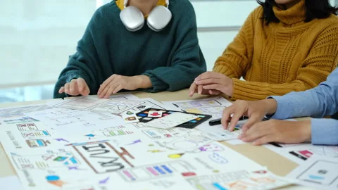 Developer team collaborating and planning template layout for mobile application Stock Footage 245178524