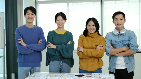 Developer team standing with arms crossed and looking confidently to camera Video stock 245174501