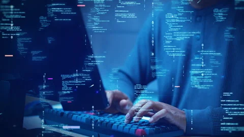 A developer types on a computer with glowing code and binary symbols overla.. Stock Footage 315020923