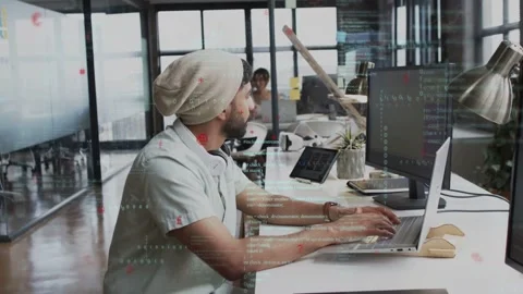 Developer typing at bench with laptop, glancing as coworker appearing, code Video stock 335282101