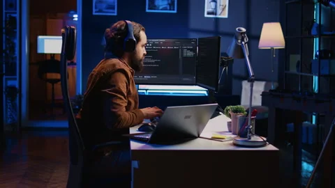 Developer typing code in home office to develop software application Stock Footage 265620548
