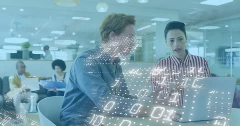 Developer typing code on laptop and activating binary grid while analyst Stock Footage 320205356