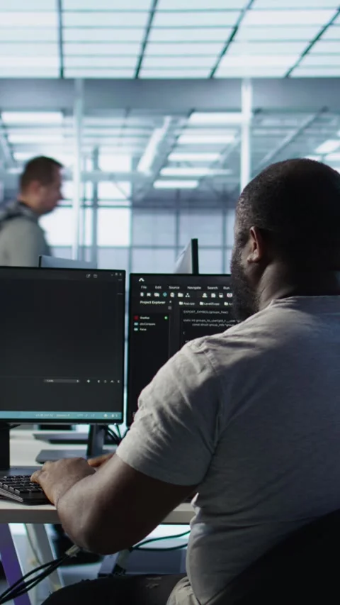 Developer typing code on PC to mend data center racks Stock Footage 319549640