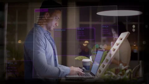 Developer typing on laptop, glancing at tablet, activating purple data boxes and Stock Footage 333034912
