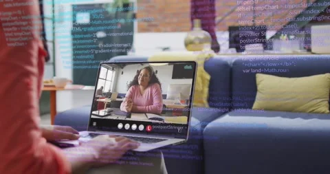 Developer typing on laptop initiating tech meeting call showing colleague as Stock Footage 317227897