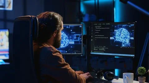 Developer uses computer to update artificial intelligence neural networks Stock Photos