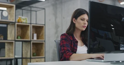 Developer using laptop computer while writing programming code at modern crea Stock Footage 113957054