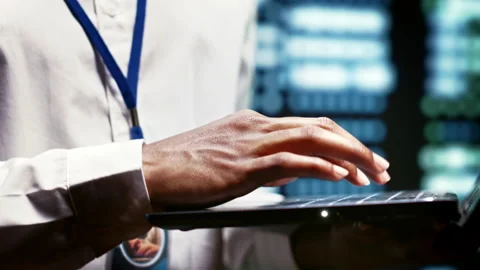 Developer using laptop to examine server 動画素材 247091537