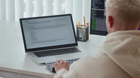 Developer Using Laptop with VLM on Screen at Office Desk Stock Footage 303558421