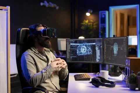 Developer using VR headset to chat with sentient artificial intelligence Stock Photos