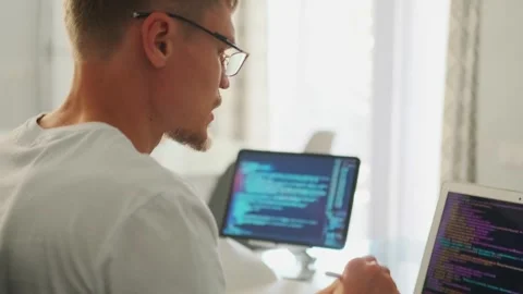 Developer video calls, explaining code with gestures on tablet and laptop. Stock Footage 296223108