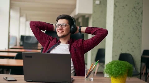 Developer, video editor man in headphones working with laptop at spacious Stock Footage 217734542