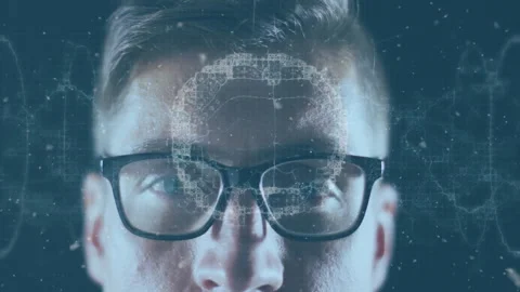 Developer wearing glasses initiating waveform, visualizing brain overlay with 库存影片 311883230