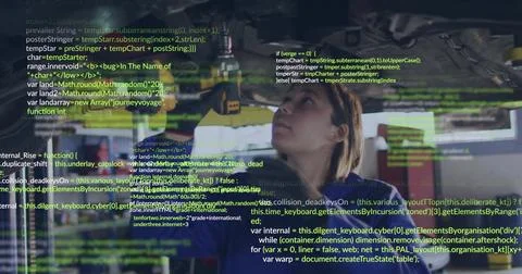 Developer wearing goggles analyzing projected JavaScript code in workshop, with 库存照片